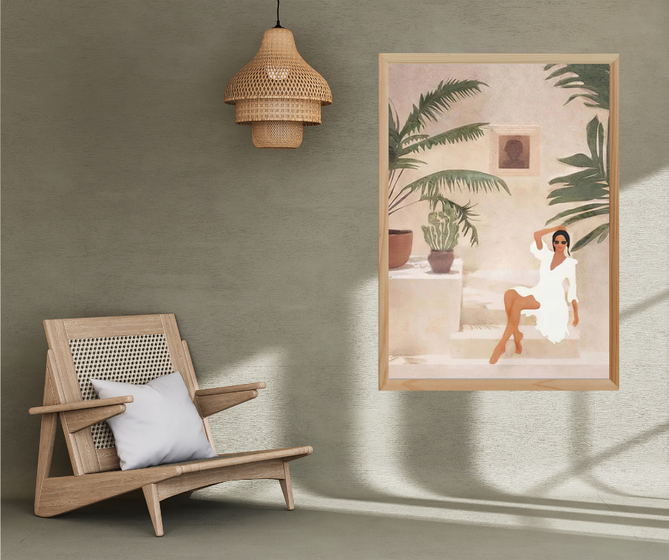 Wooden chair with a white pillow next to a framed artwork of a woman in a white dress on a green wall.